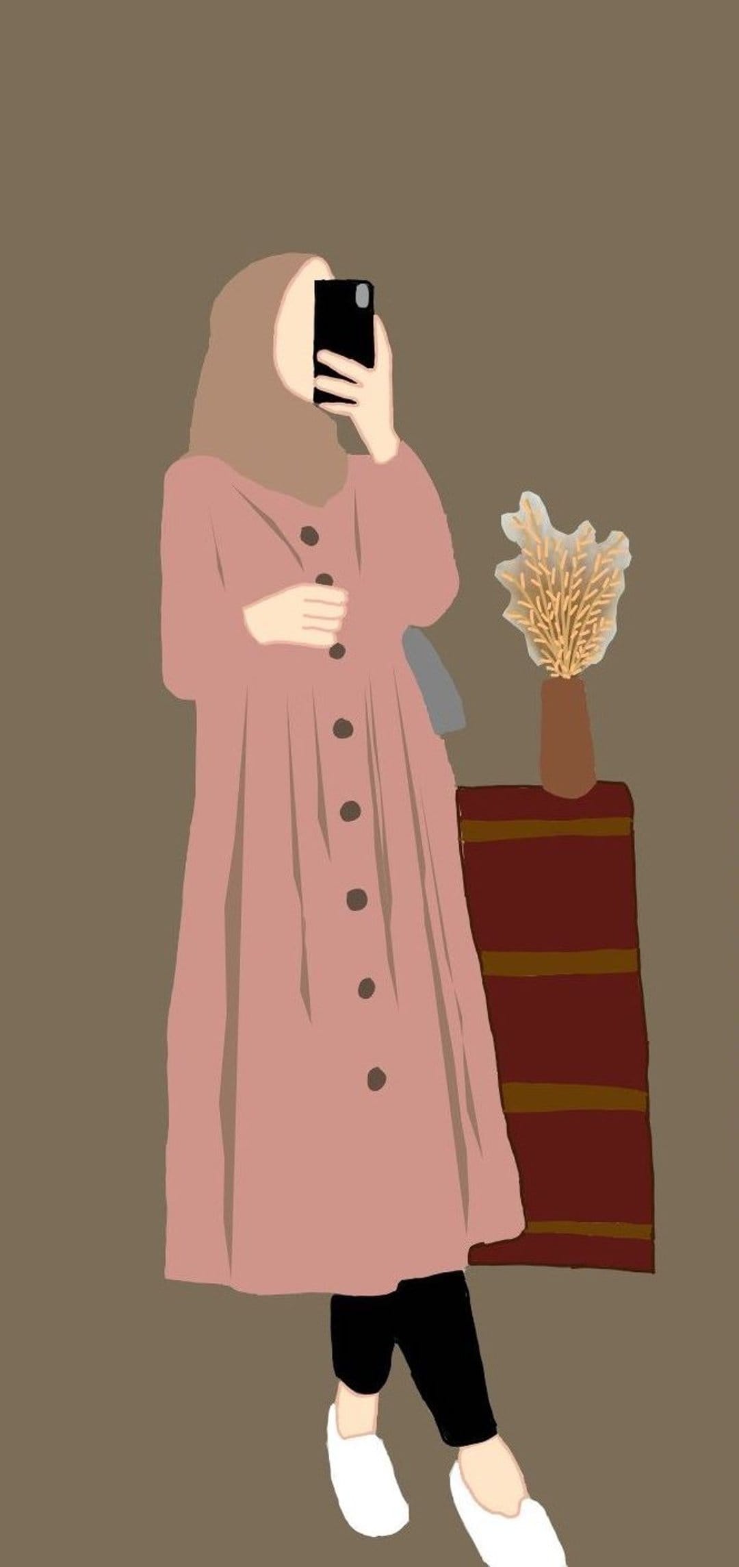 Woman in a pink dress and hijab takes a selfie near a vase of dried flowers against a dark brown background.