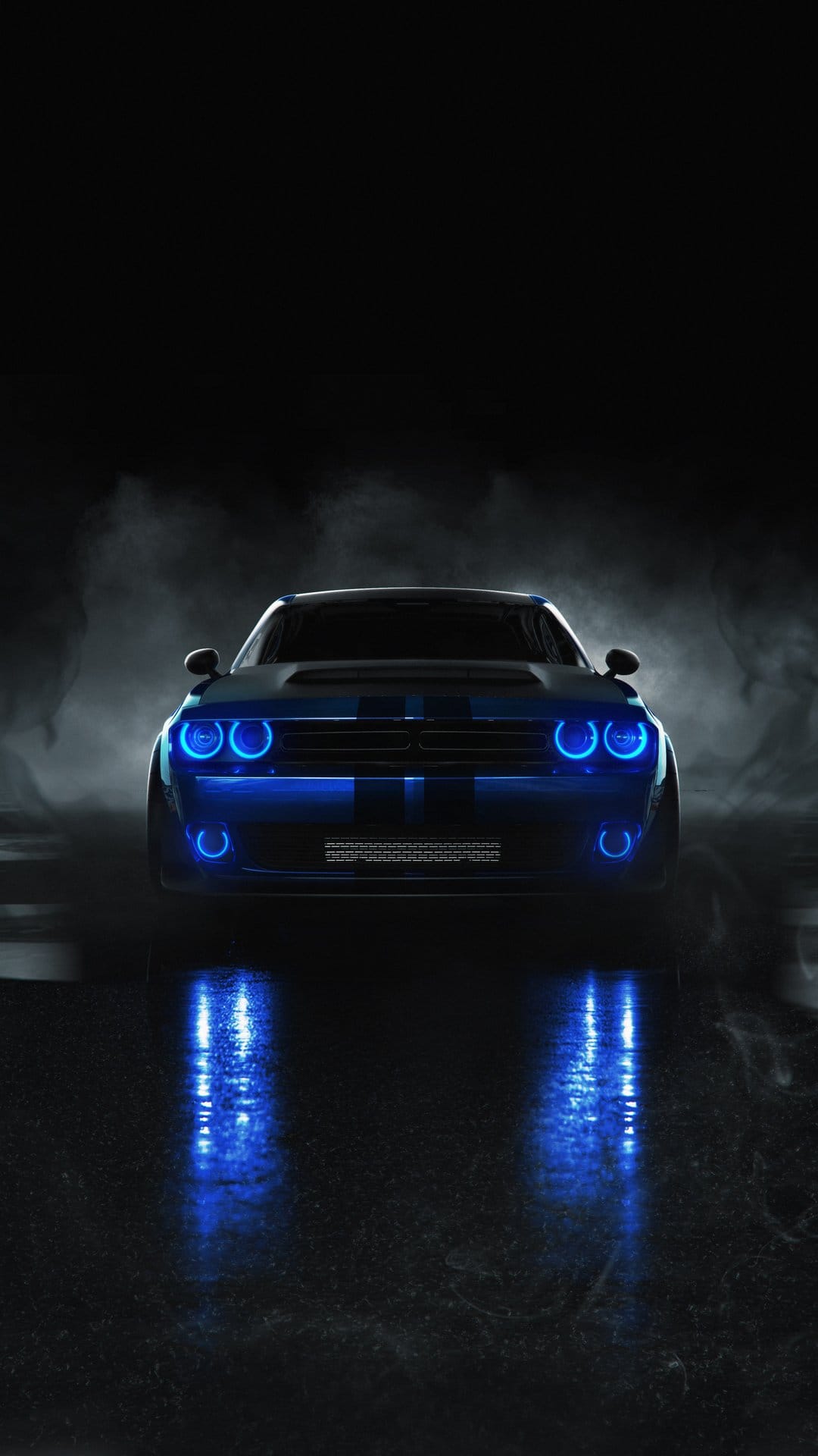 Dodge Challenger with blue LED lights on a wet road surrounded by thick smoke and dark nocturnal shadows.