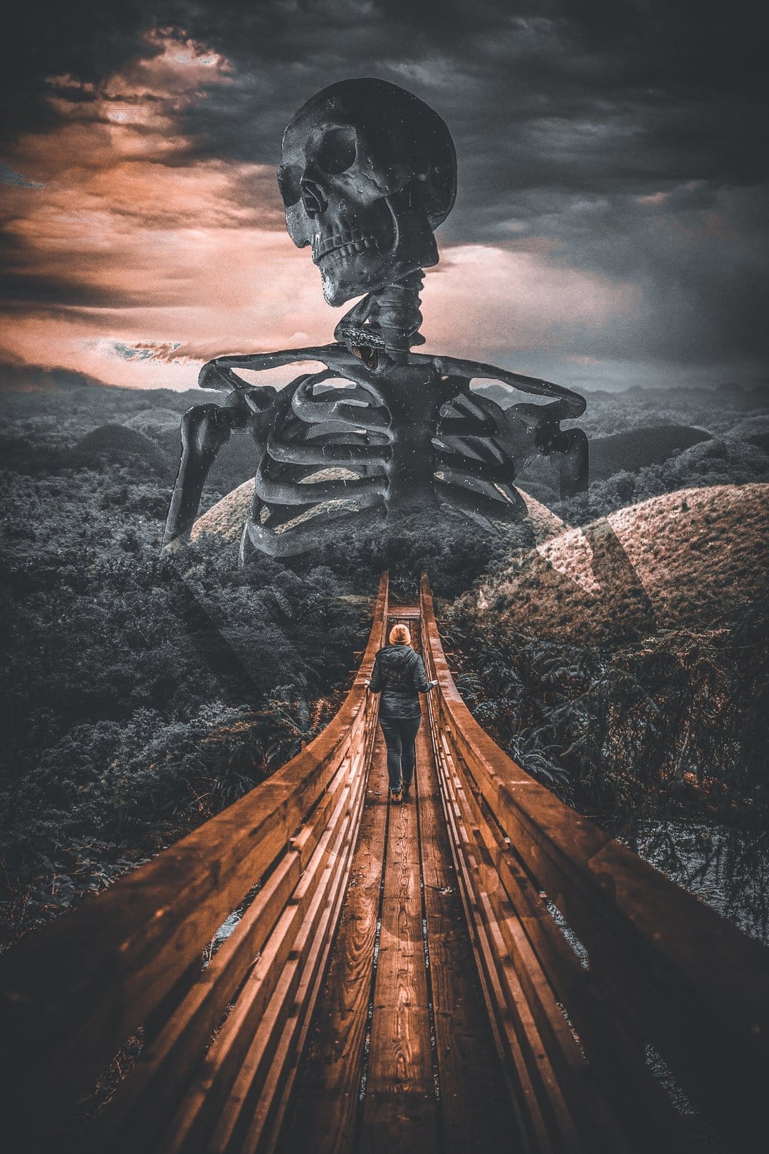 Colossal skeleton towers over a person walking across a rope bridge amid thick fog and dark mountain cliffs.