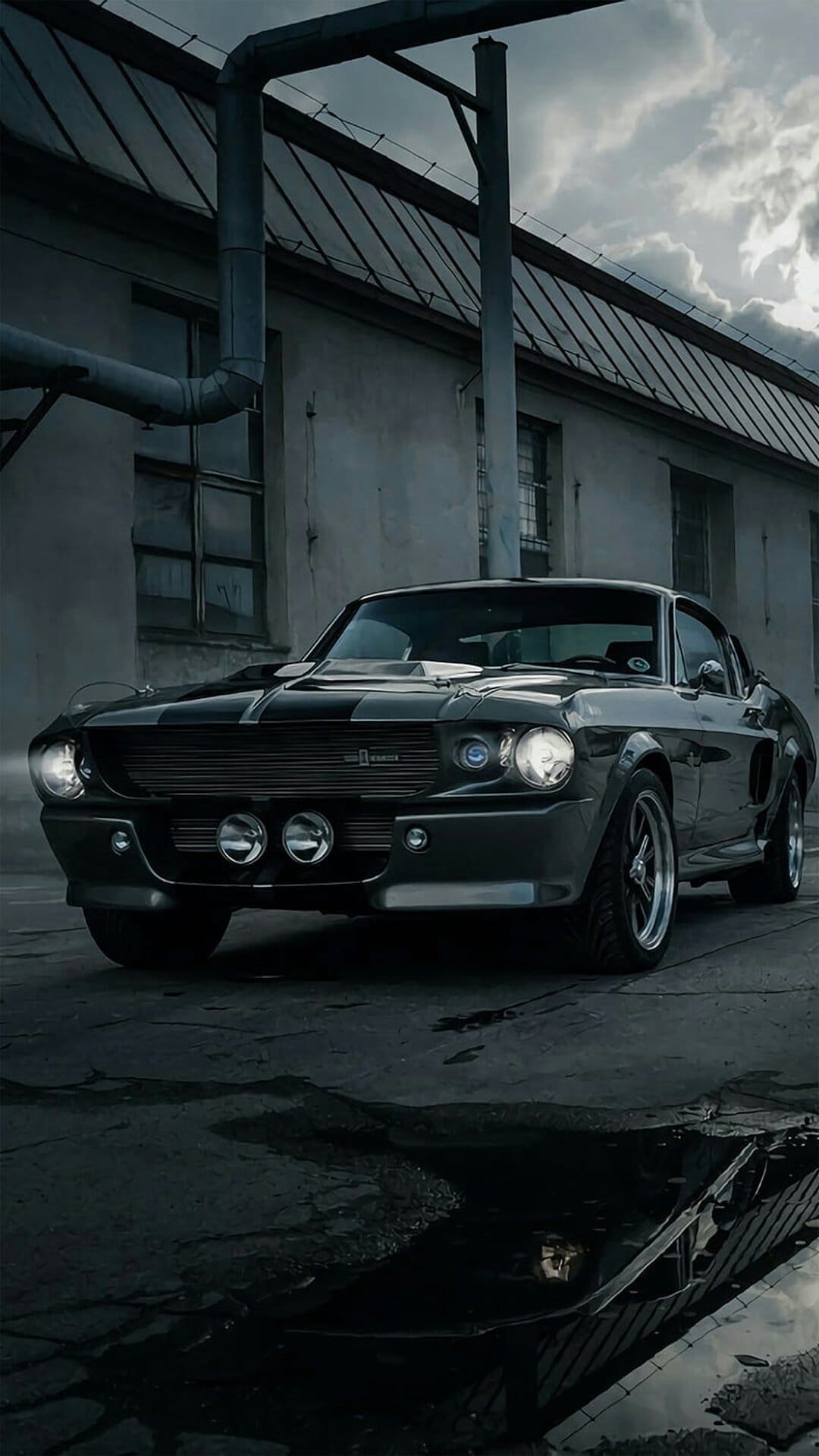 Eleanor Shelby GT500 Mustang parked on wet asphalt near a weathered industrial building under a cloudy sky.