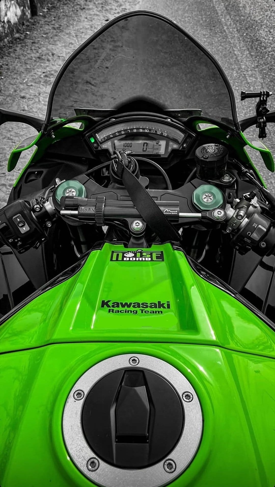 Kawasaki Racing Team green fuel tank and motorcycle dashboard viewed from the rider's first-person perspective.