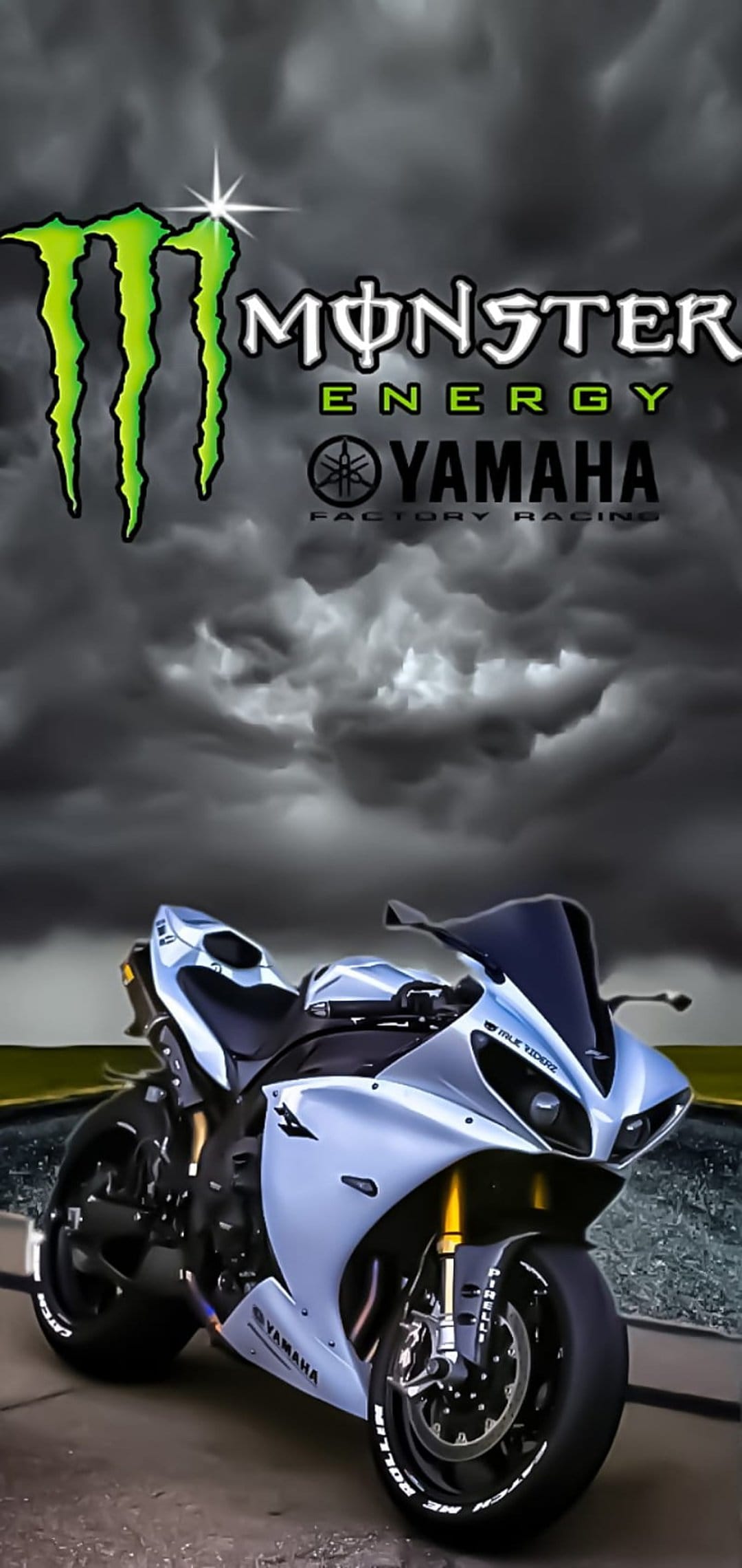 Yamaha R1 motorcycle with Monster Energy racing decals parked under a dramatic sky with dark storm clouds.