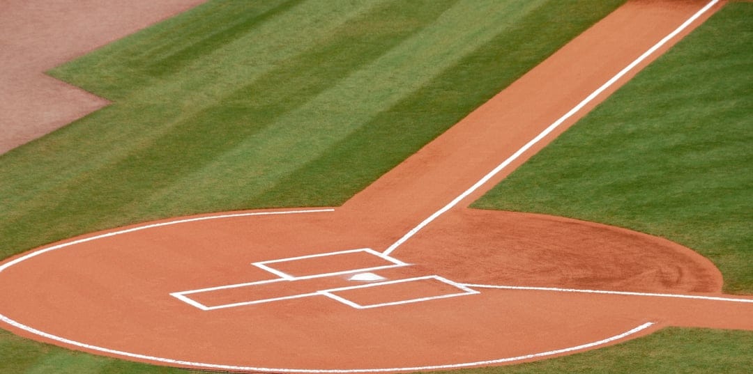 Manicured baseball infield showing the pitcher's mound, batter's box, and home plate with crisp white lines.