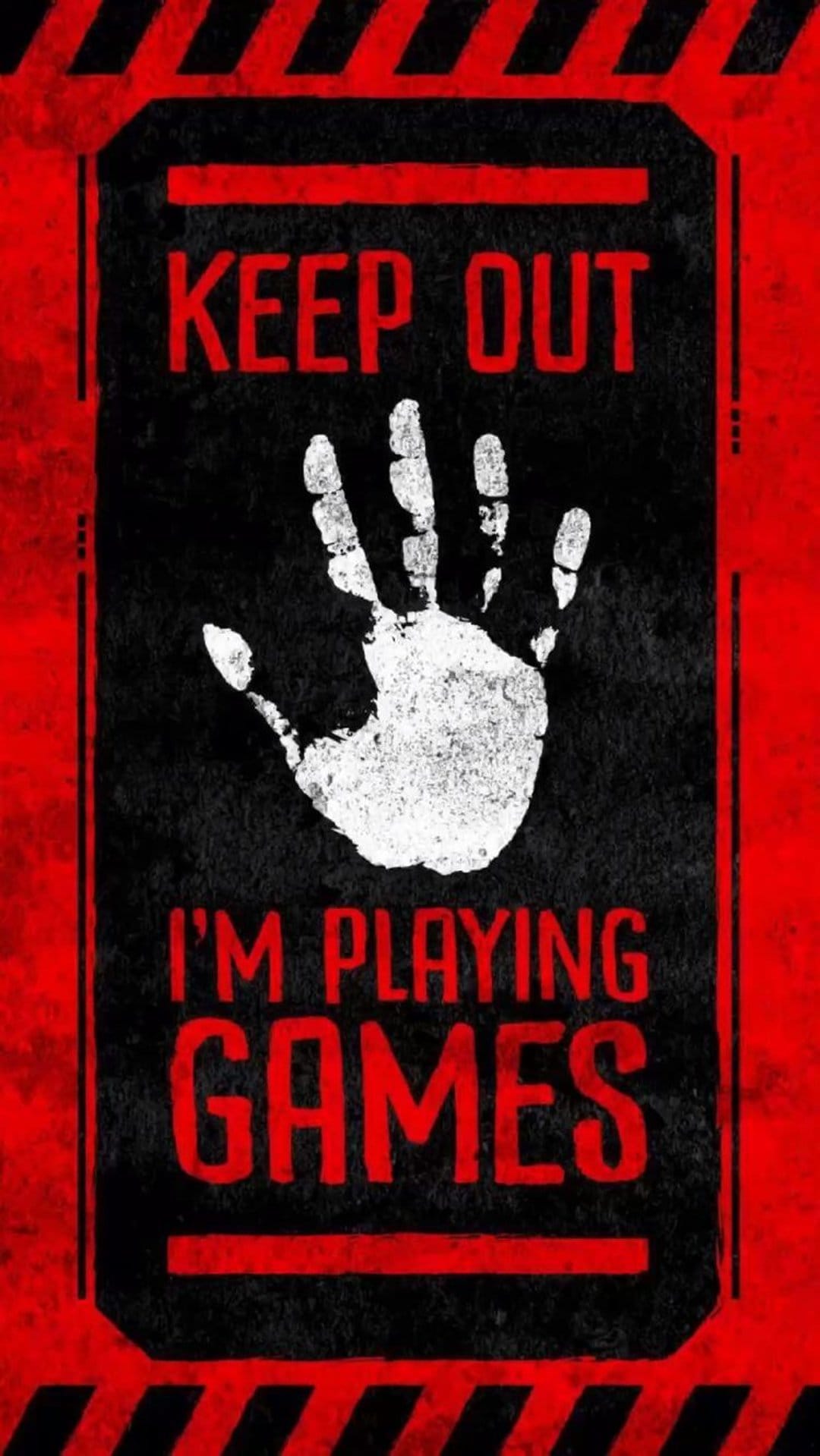 Keep Out I'm Playing Games sign featuring a white handprint on distressed black with red hazard borders.