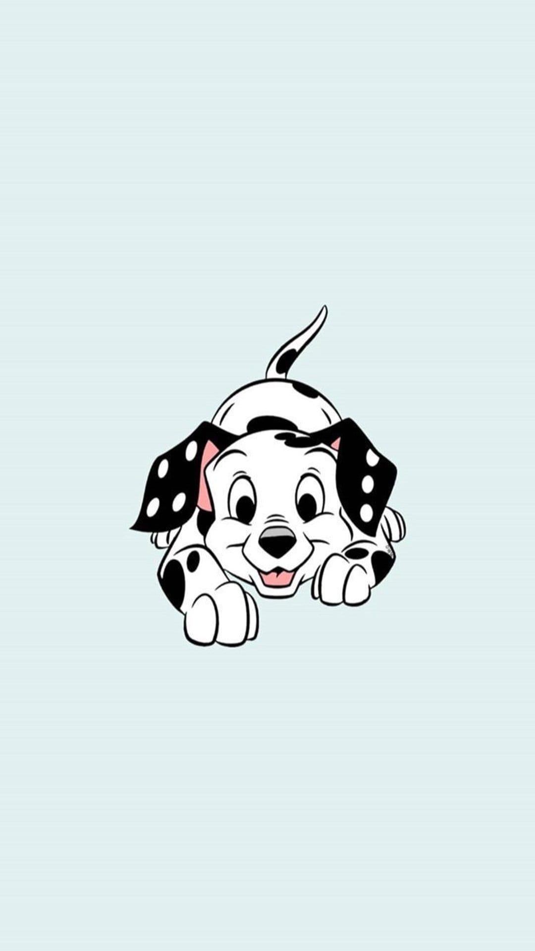 Spotted Dalmatian puppy wags its tail with a happy expression against a solid light blue background.
