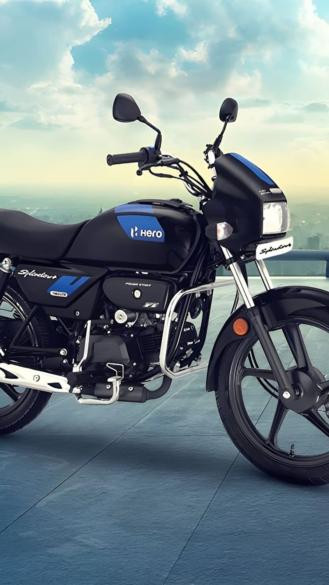 Hero Splendor Plus motorcycle in black and blue with side profile view against a soft cloudy sky background.