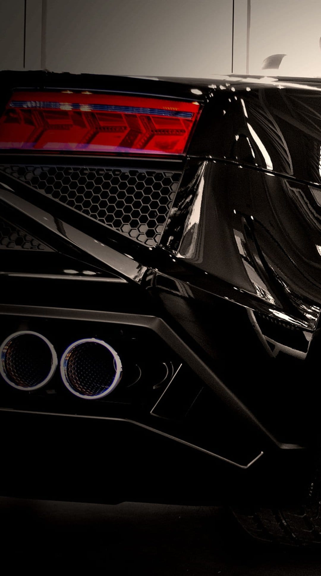 Black Lamborghini rear end featuring glowing red chevron tail lights, dual exhausts, and a dark hexagonal grille.