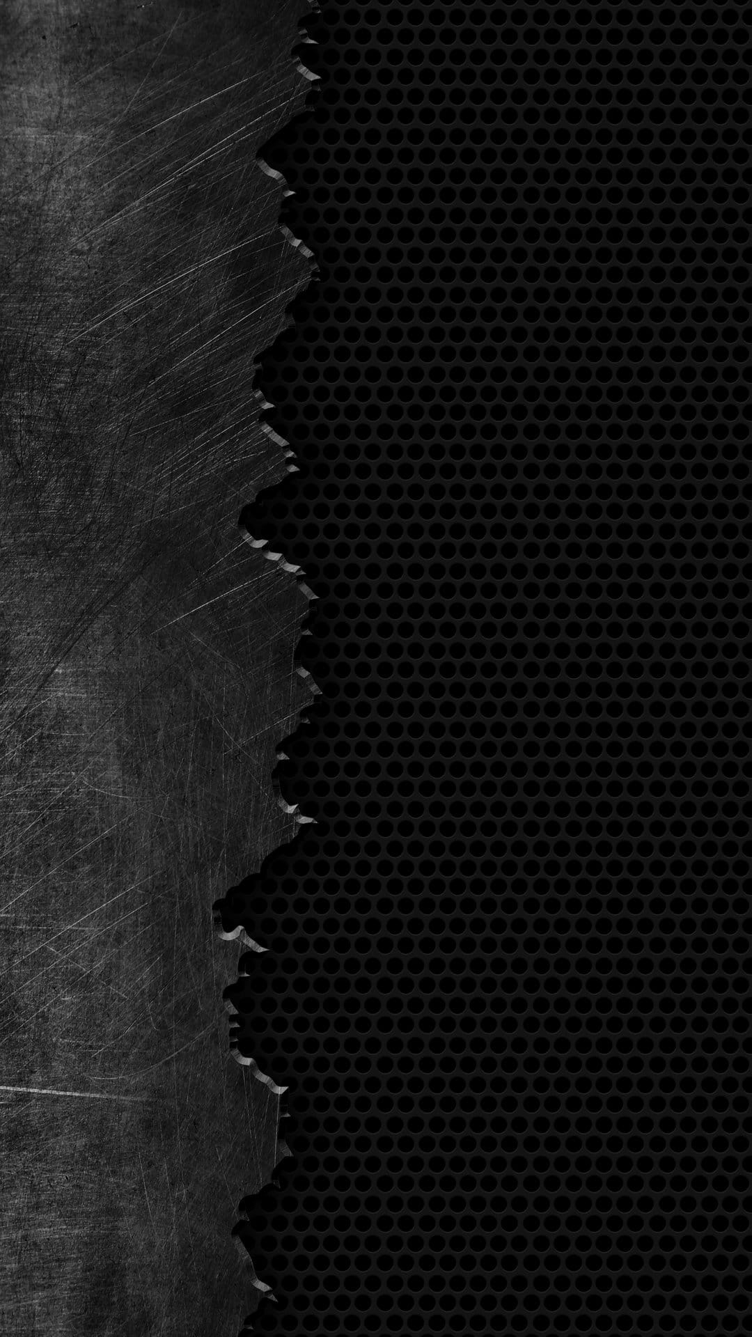 Scratched steel plating torn away to expose a black honeycomb mesh pattern with deep shadows and industrial texture