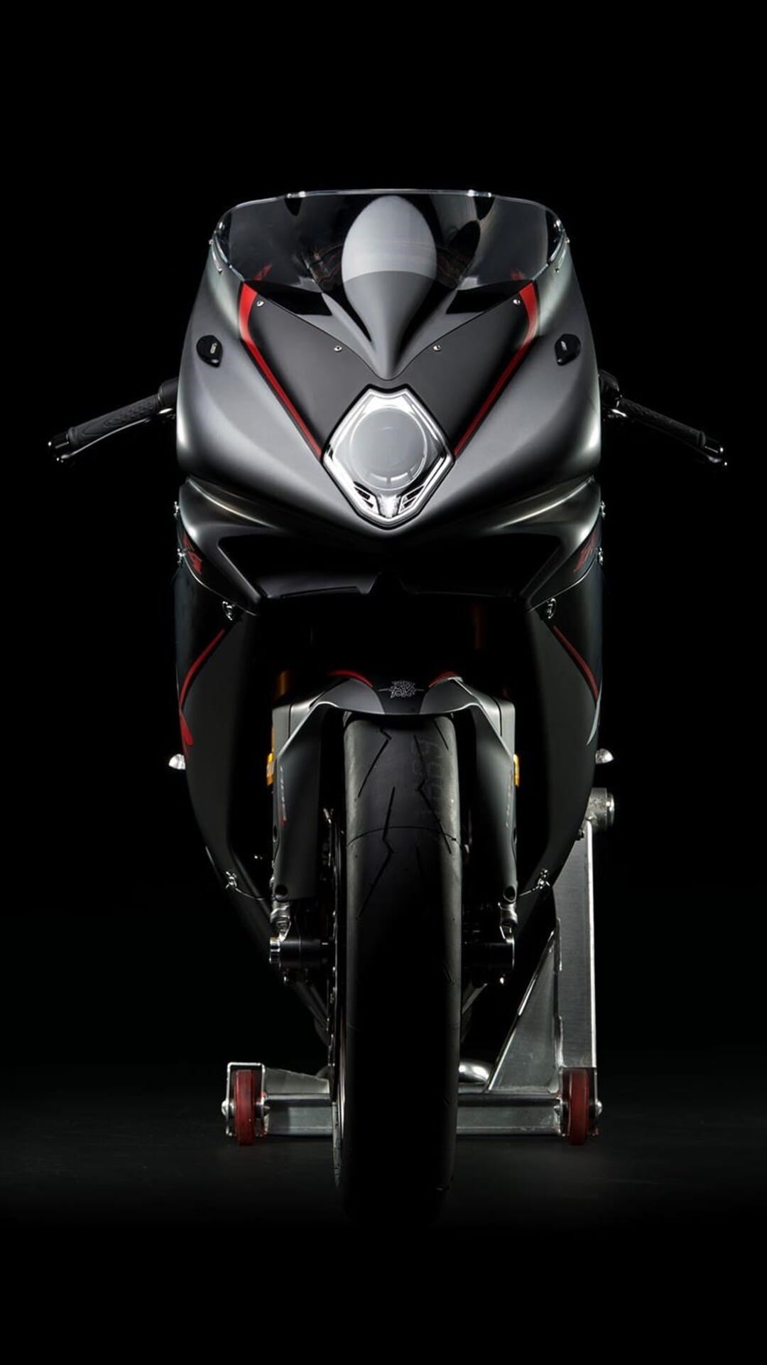 MV Agusta superbike front view features a dark metallic body with red racing stripes against a black background.