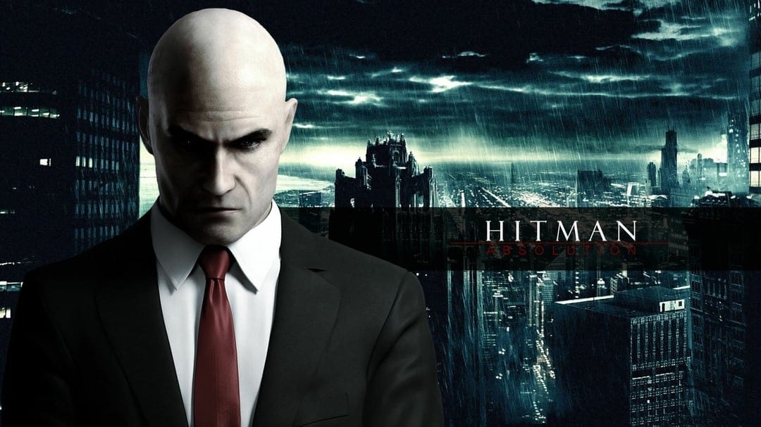 Agent 47 in a black suit and red tie stands before a rainy city skyline at night under dark storm clouds.