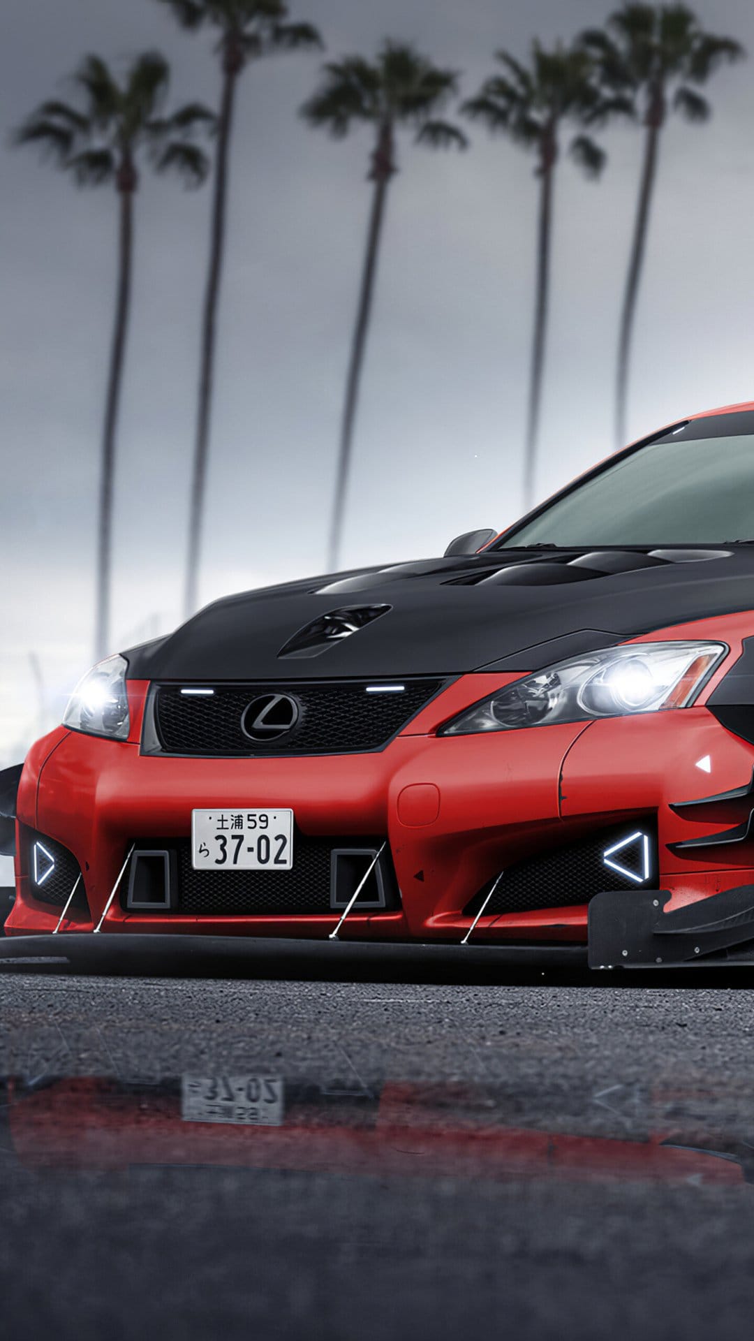 Red Lexus IS with a black vented hood and widebody kit parked on wet pavement under palm trees.