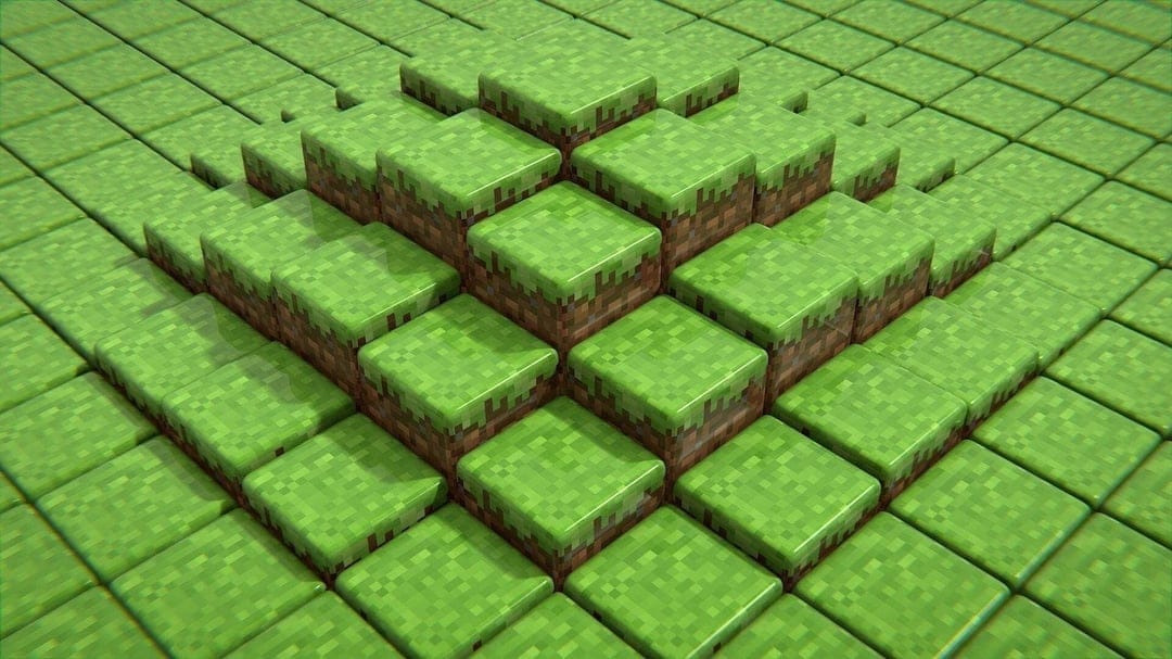 Isometric view of a 3D pyramid made of glossy green Minecraft-style grass blocks with soft shadows.