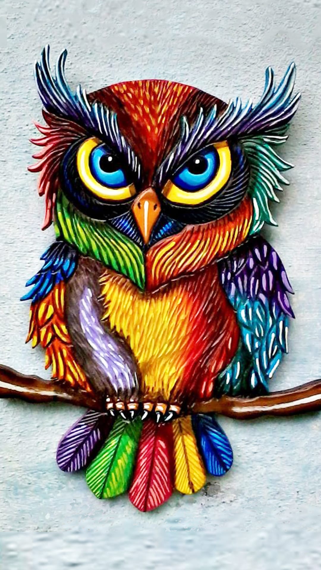 Multi-colored owl with neon feathers and intense yellow eyes stares forward in a vertical portrait view.