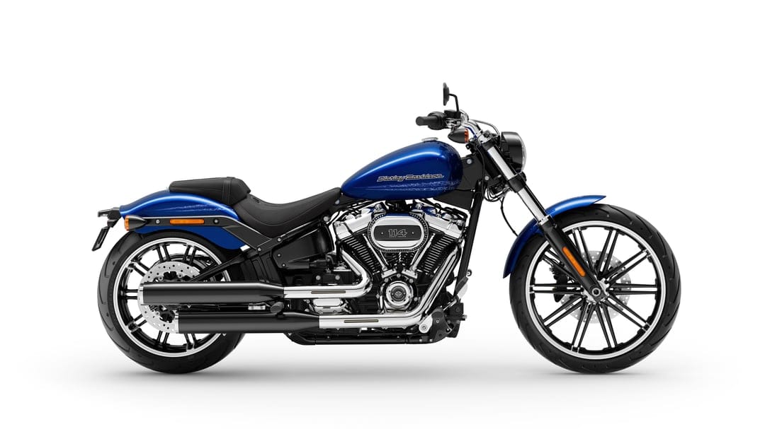 Blue Harley-Davidson Breakout motorcycle with a chrome V-twin engine and black exhaust against a white backdrop.
