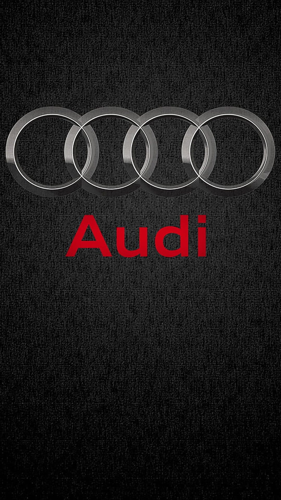 Audi silver interlocking rings logo positioned above red text on a black textured carbon-style background.