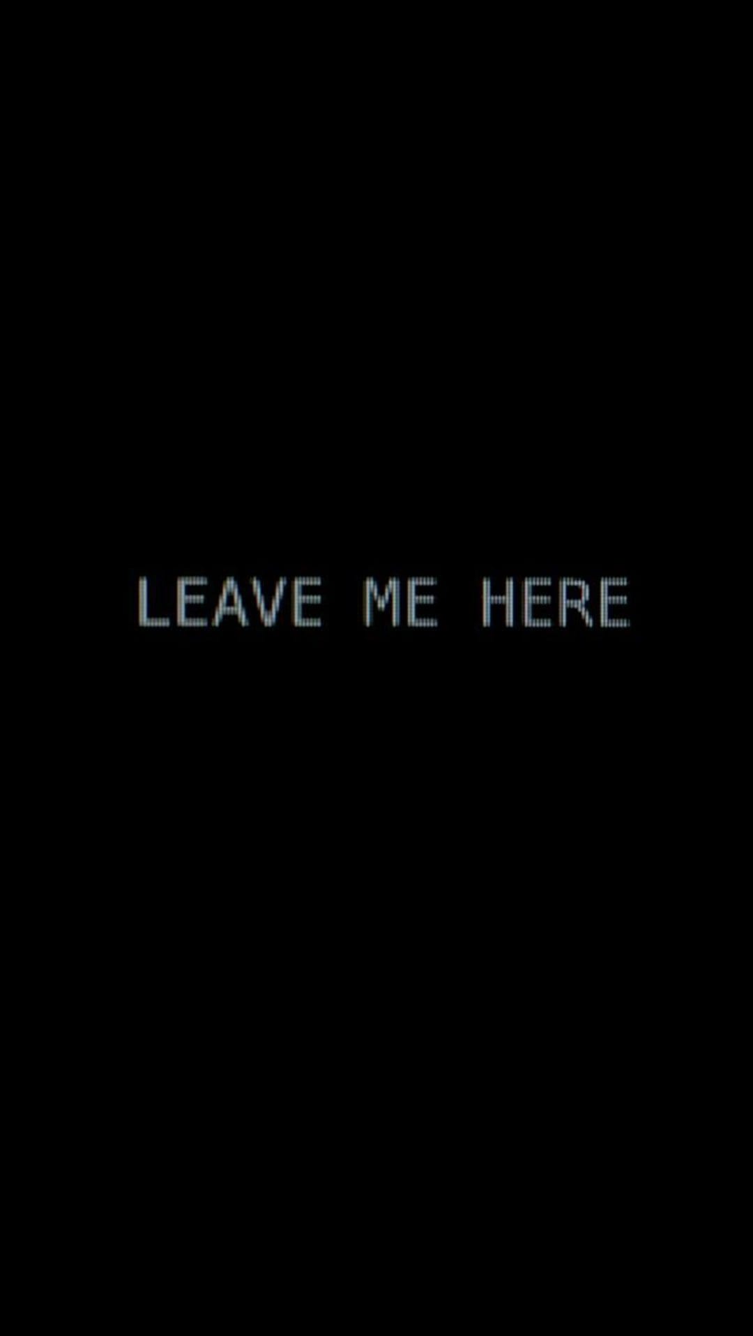 White pixelated Leave Me Here text centered on a solid black background creating a high-contrast minimalist scene.