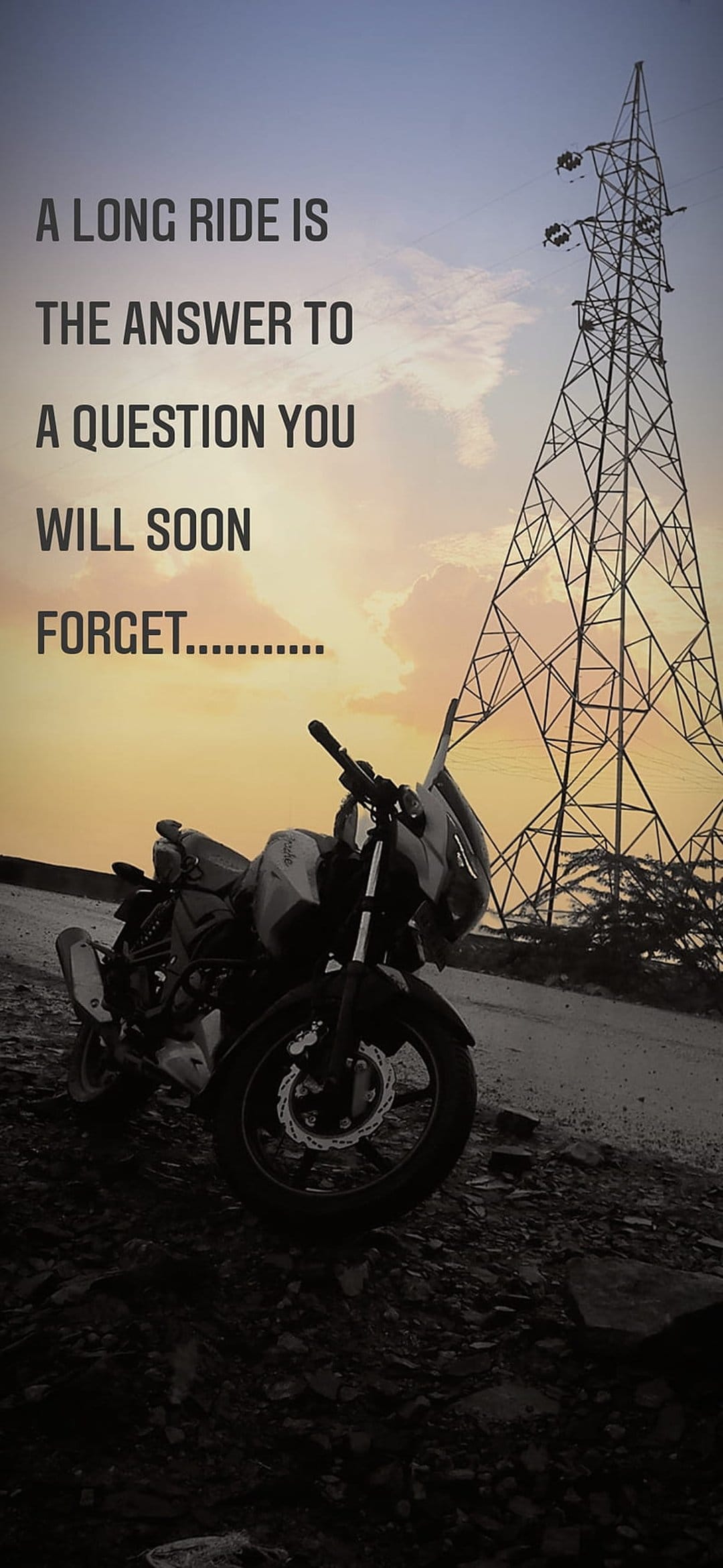 Motorcycle parked beside an electric pylon under a fiery orange sunset with an inspirational text overlay.