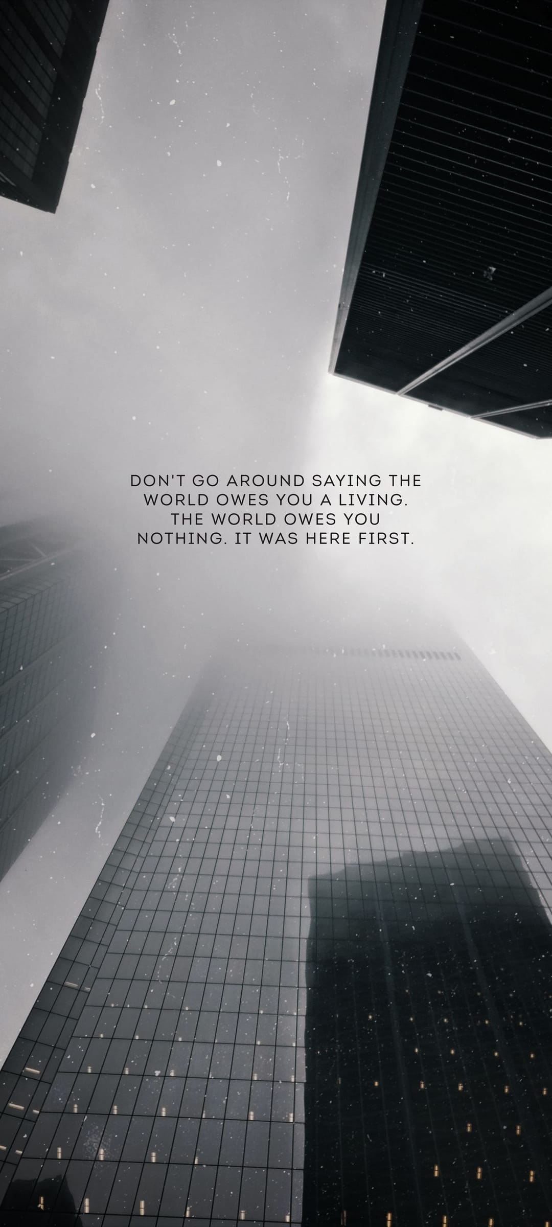 Towering skyscrapers rising into a dense fog with a text overlay about life and responsibility in monochrome.