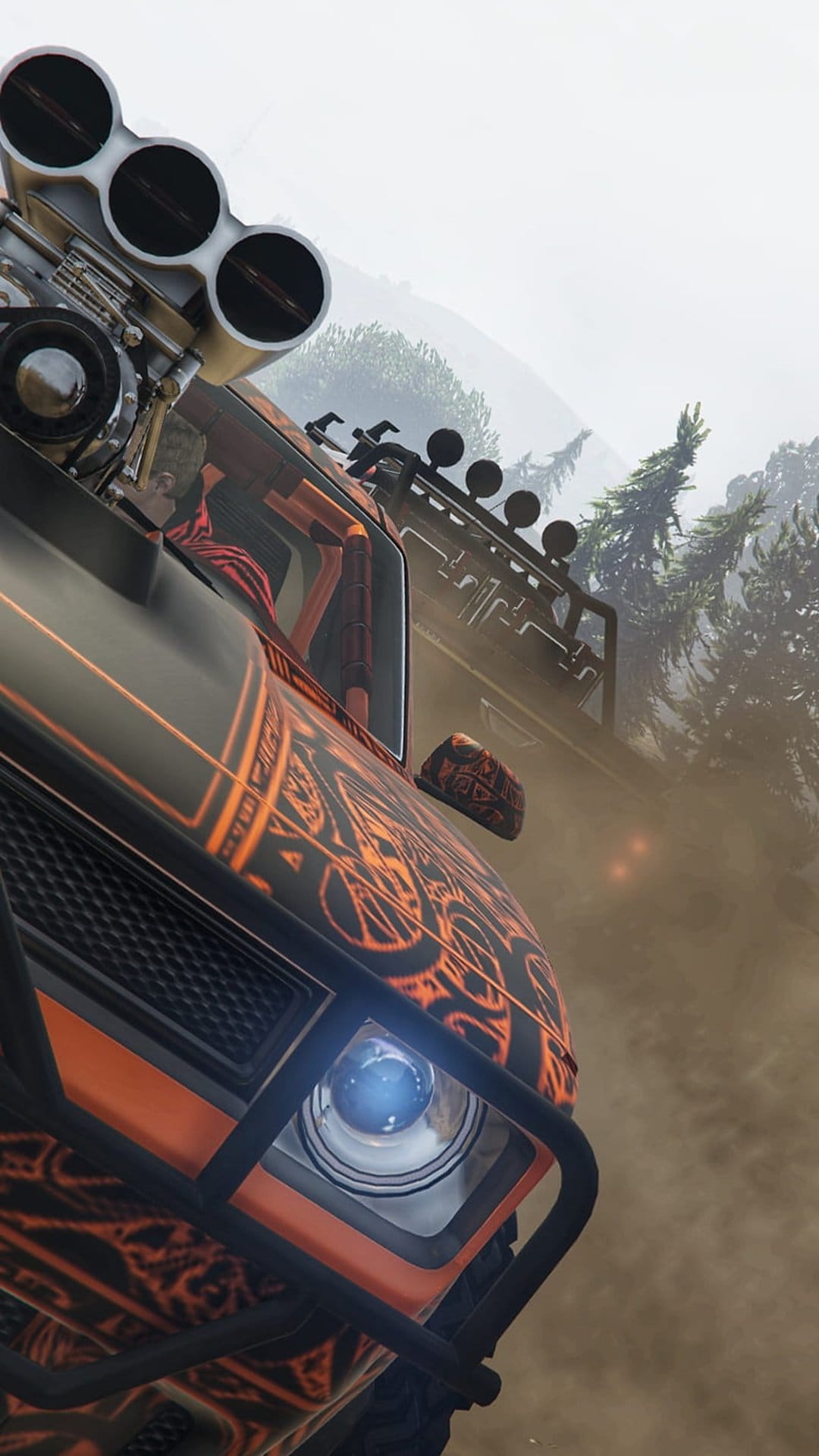 Rugged 4x4 vehicle with orange decals navigates a foggy pine forest with an illuminated roof-mounted light bar.