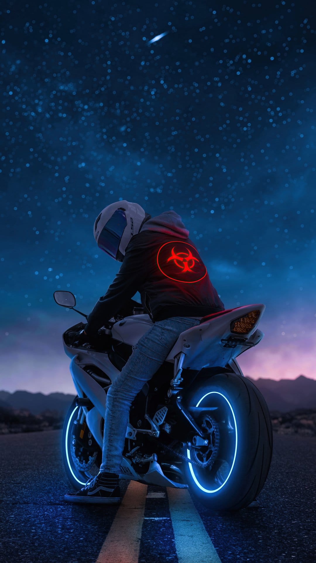Motorcycle rider with glowing blue wheels and a red biohazard symbol under a purple starry night sky.