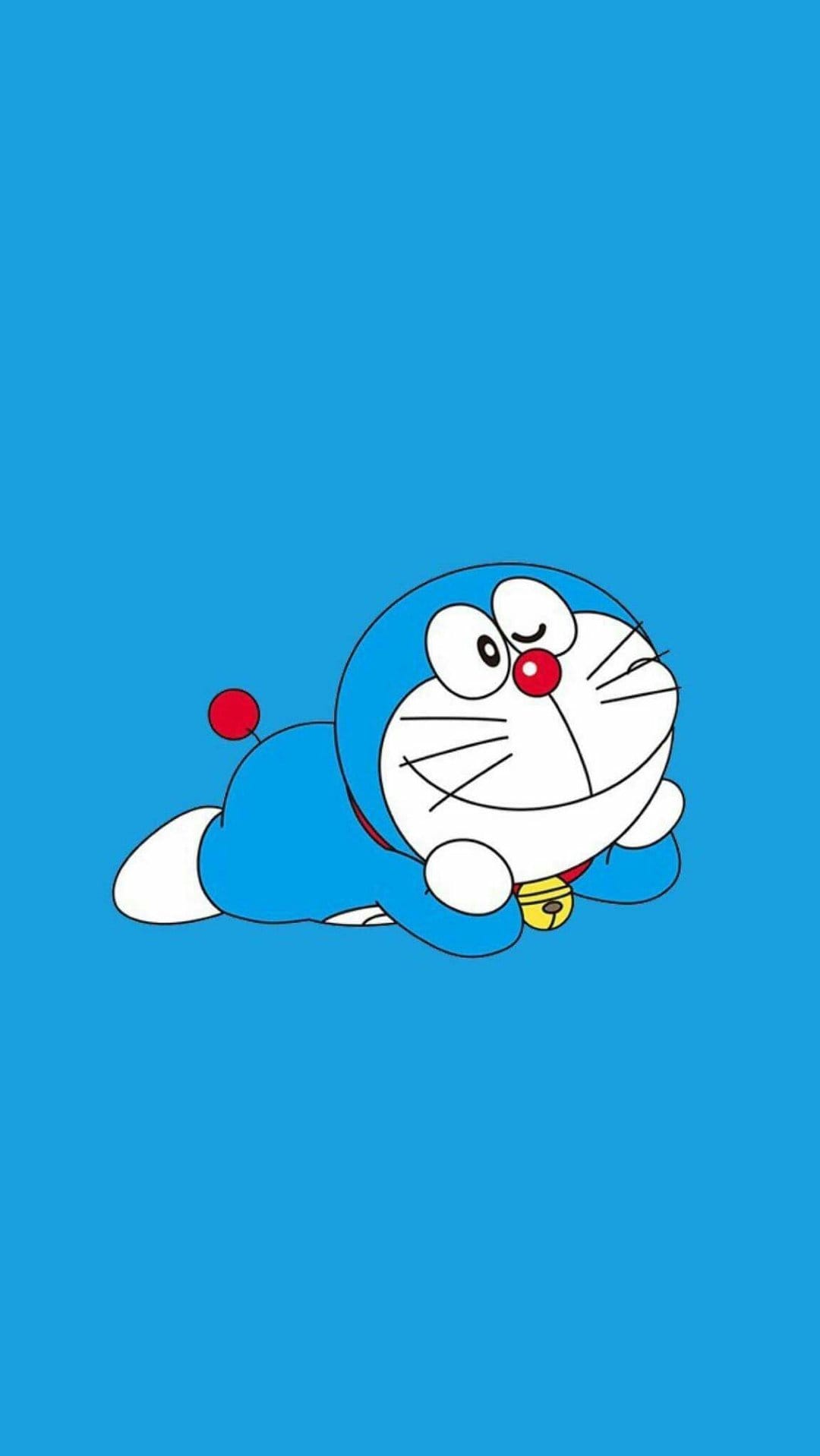 Doraemon lies on his side with a joyful expression and golden bell against a solid bright blue background.