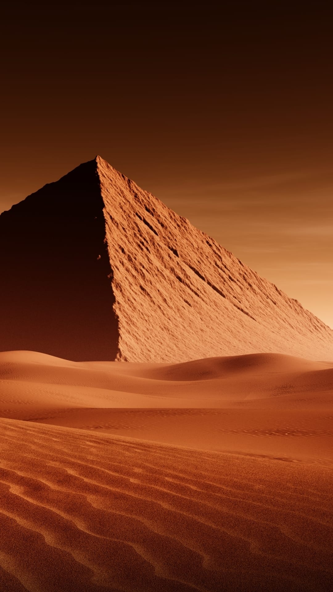 Ancient pyramid rises behind rippled sand dunes under a hazy orange sky in a monochromatic desert landscape.
