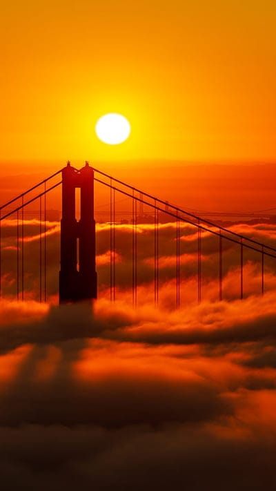 travel destination, California, atmospheric, orange sky, cityscape, golden hour, iconic landmark, bridge silhouette, vibrant colors, Golden Gate Bridge, San Francisco, nature, sunset, sea of fog, fog, clouds, sun, travel photography, American landmark, scenic view, architecture