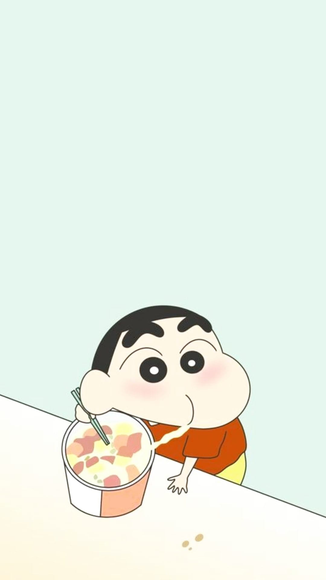 Shinnosuke Nohara eats noodles with chopsticks over a white table wearing an orange shirt on a blue backdrop.