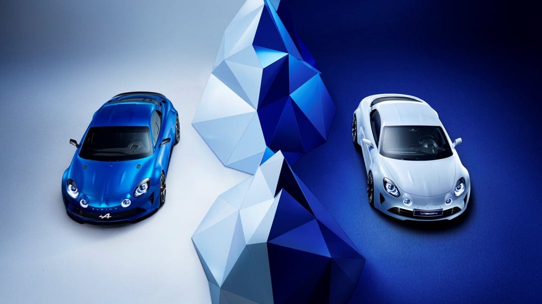 Blue and white Alpine sports cars parked on a split-color background with geometric mountain structures.