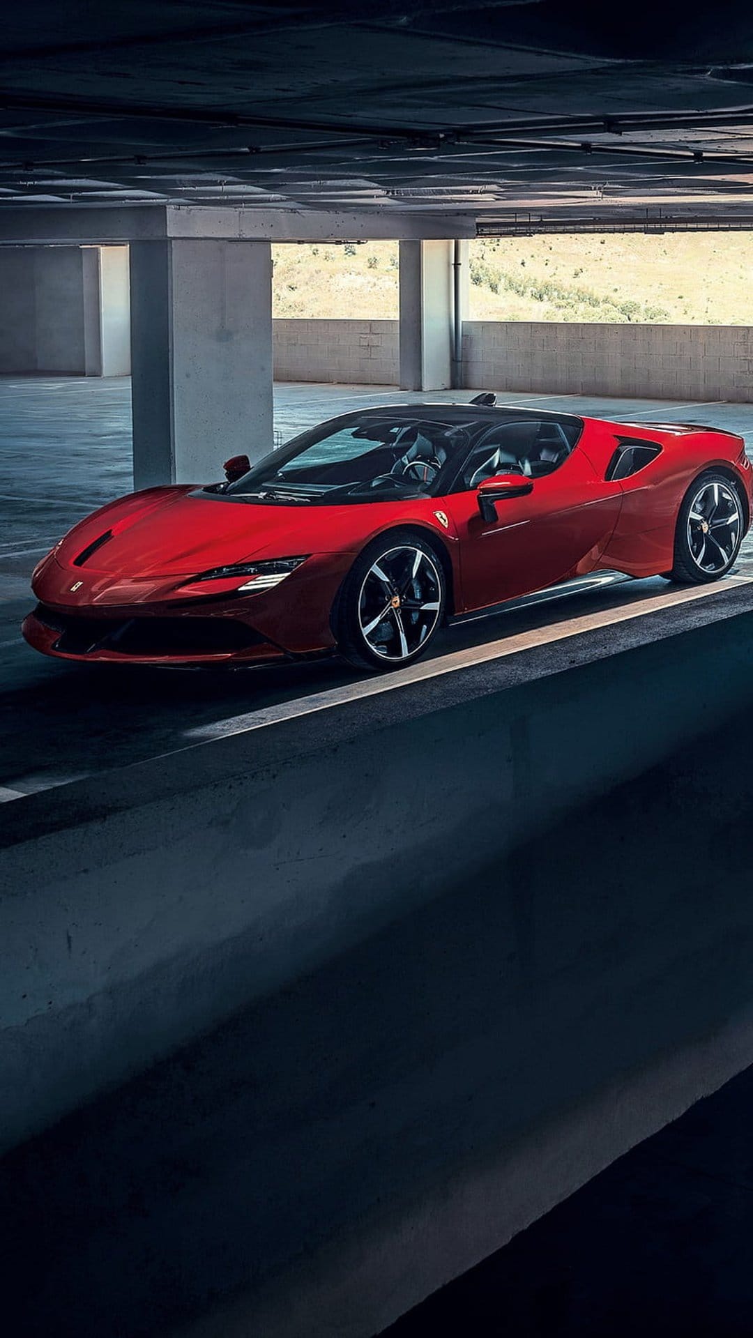 Red Ferrari SF90 Stradale supercar parked in a dimly lit concrete garage with sharp highlights on its body.