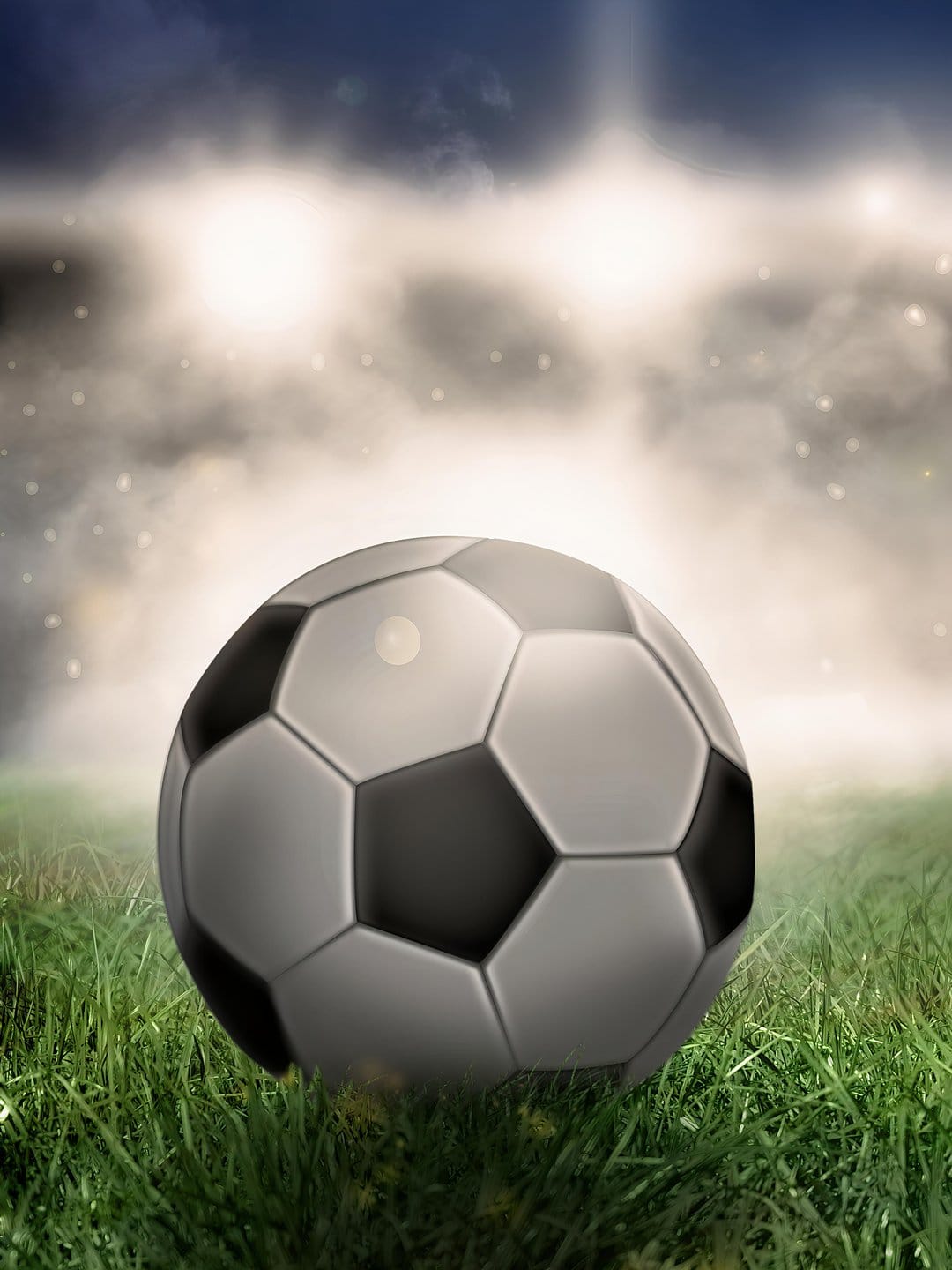Soccer ball on green grass illuminated by bright stadium floodlights against a misty and dark night sky.