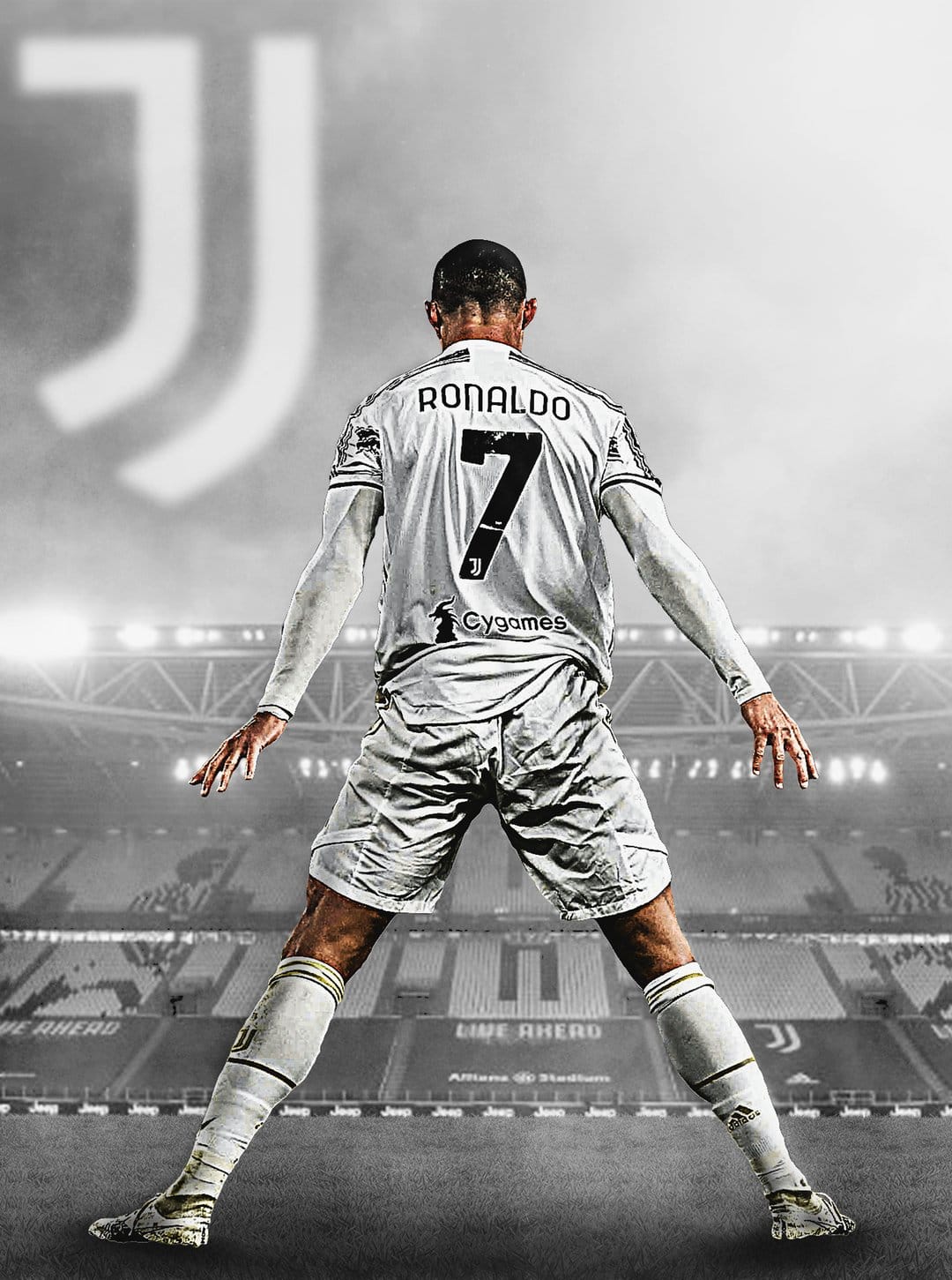 Cristiano Ronaldo stands in a white Juventus kit viewed from behind in a high-contrast monochrome stadium scene.