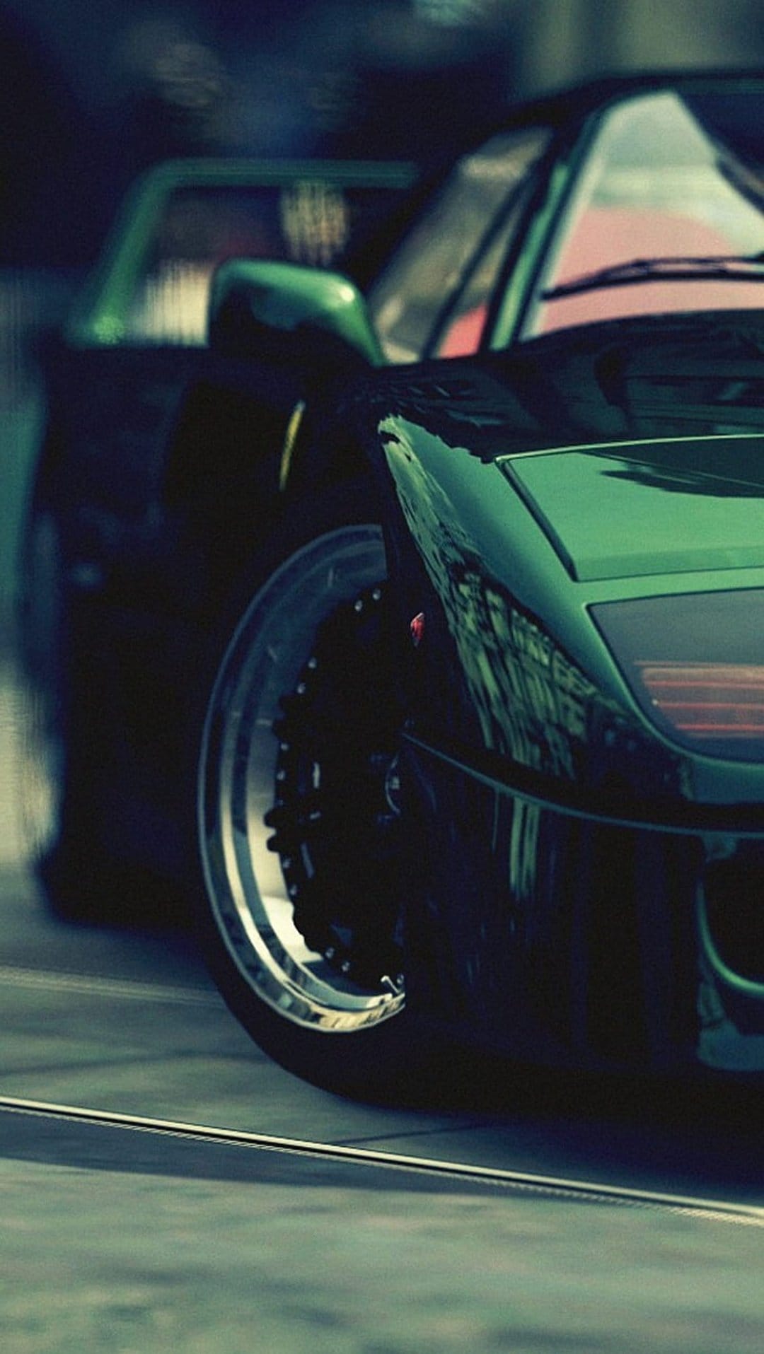 Lime green sports car wheel and polished metallic rim with sharp light reflections on the curved front fender.