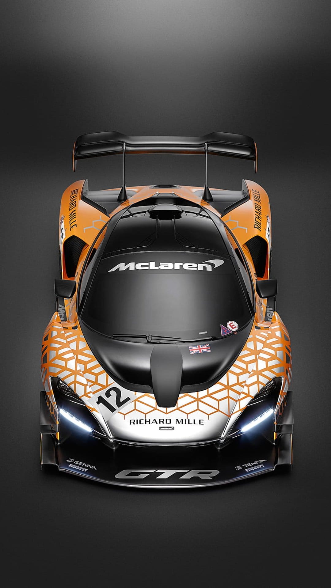 McLaren Senna GTR race car in orange with geometric decals and number twelve on a dark minimalist background.