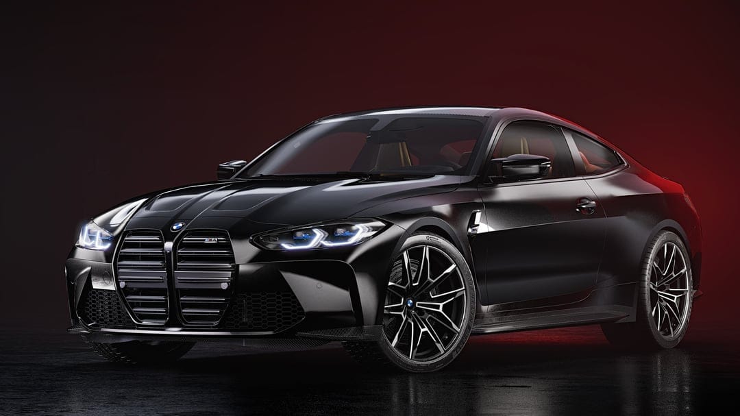 Black BMW M4 sports car with glowing blue headlights in a dark studio with a vibrant red background light.
