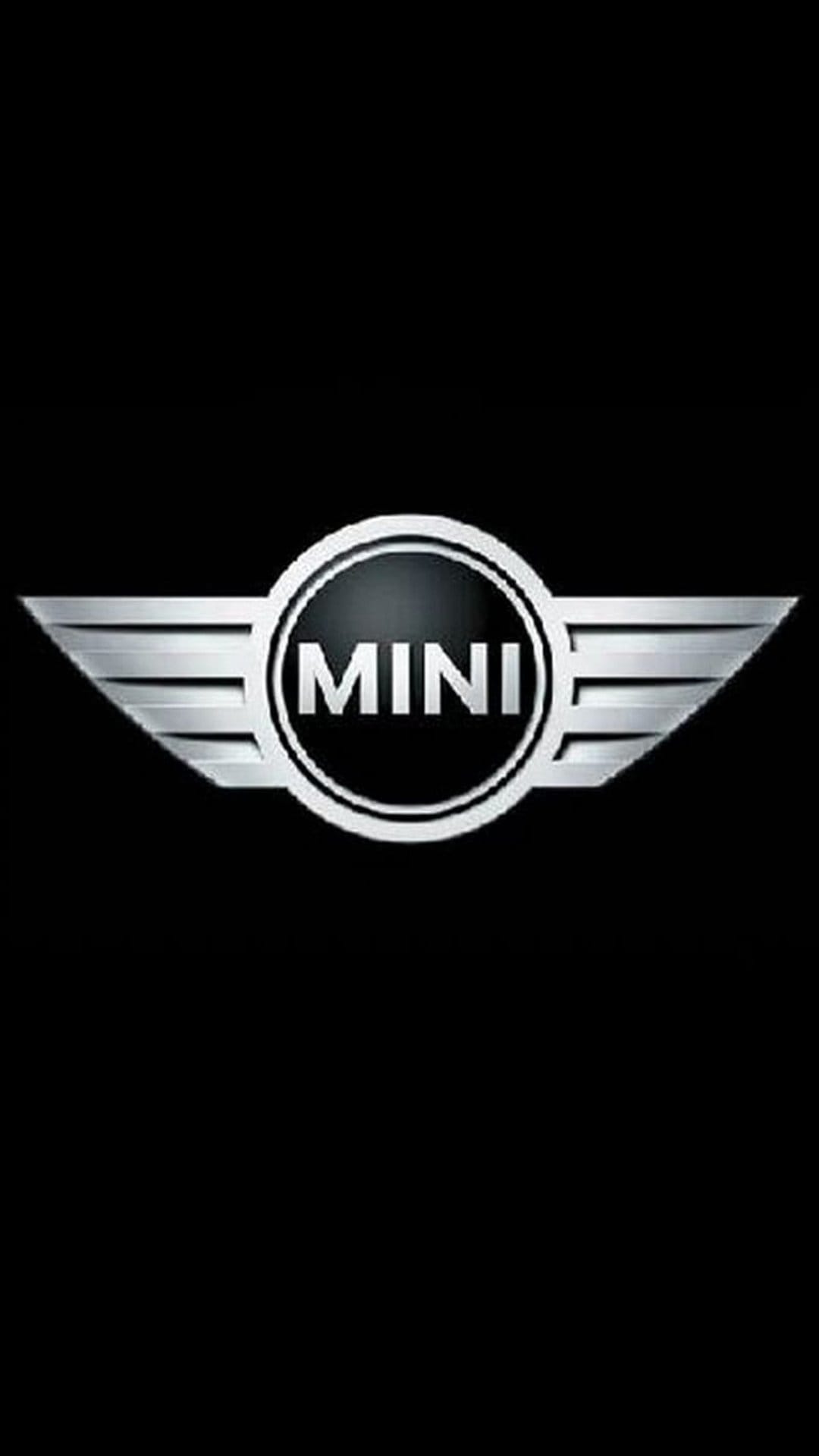 Silver MINI Cooper winged emblem centered on a solid black background with metallic textures and chrome finish.