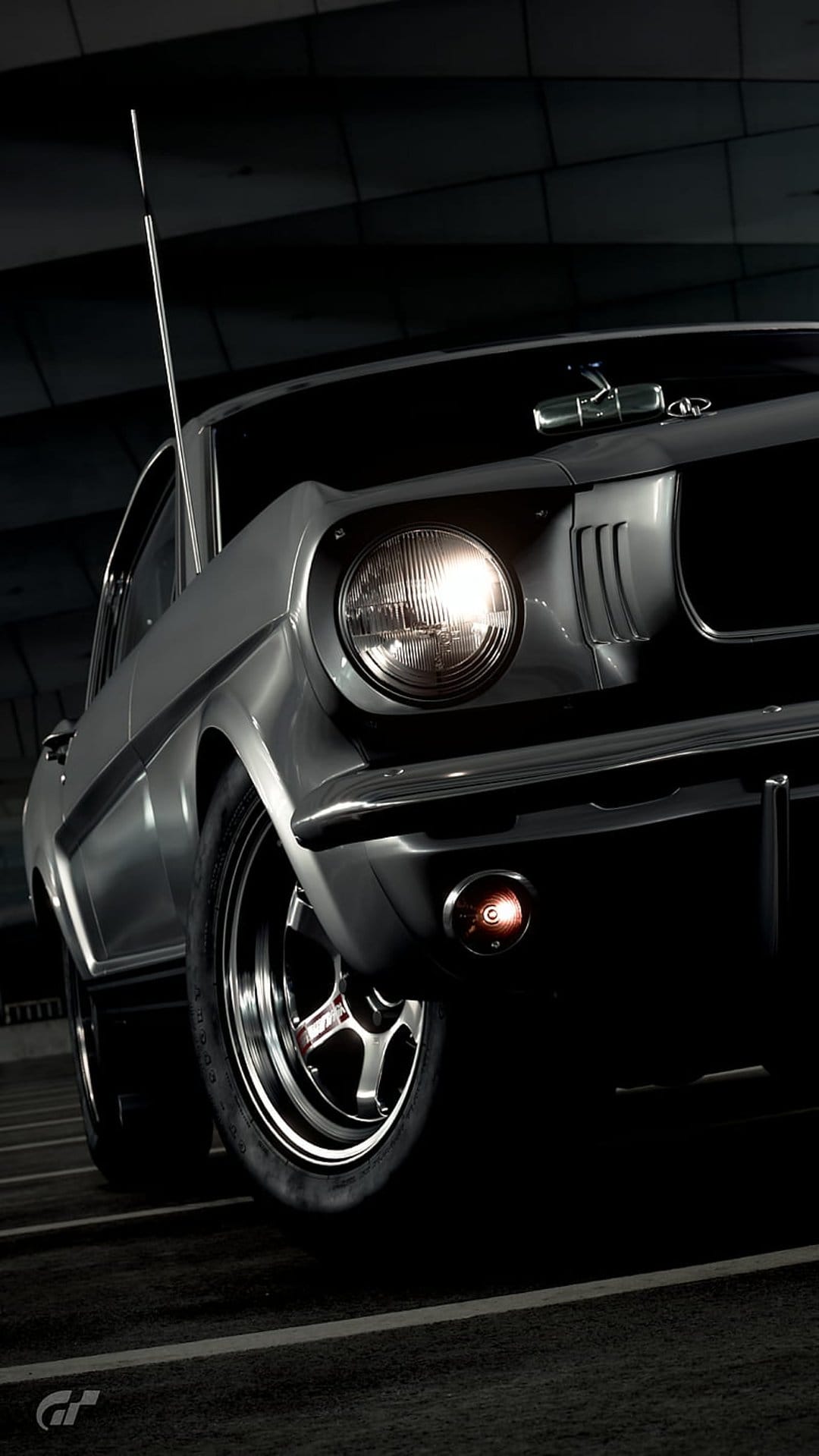 Silver Ford Mustang GT front profile featuring a glowing round headlight, chrome trim, and dark background.