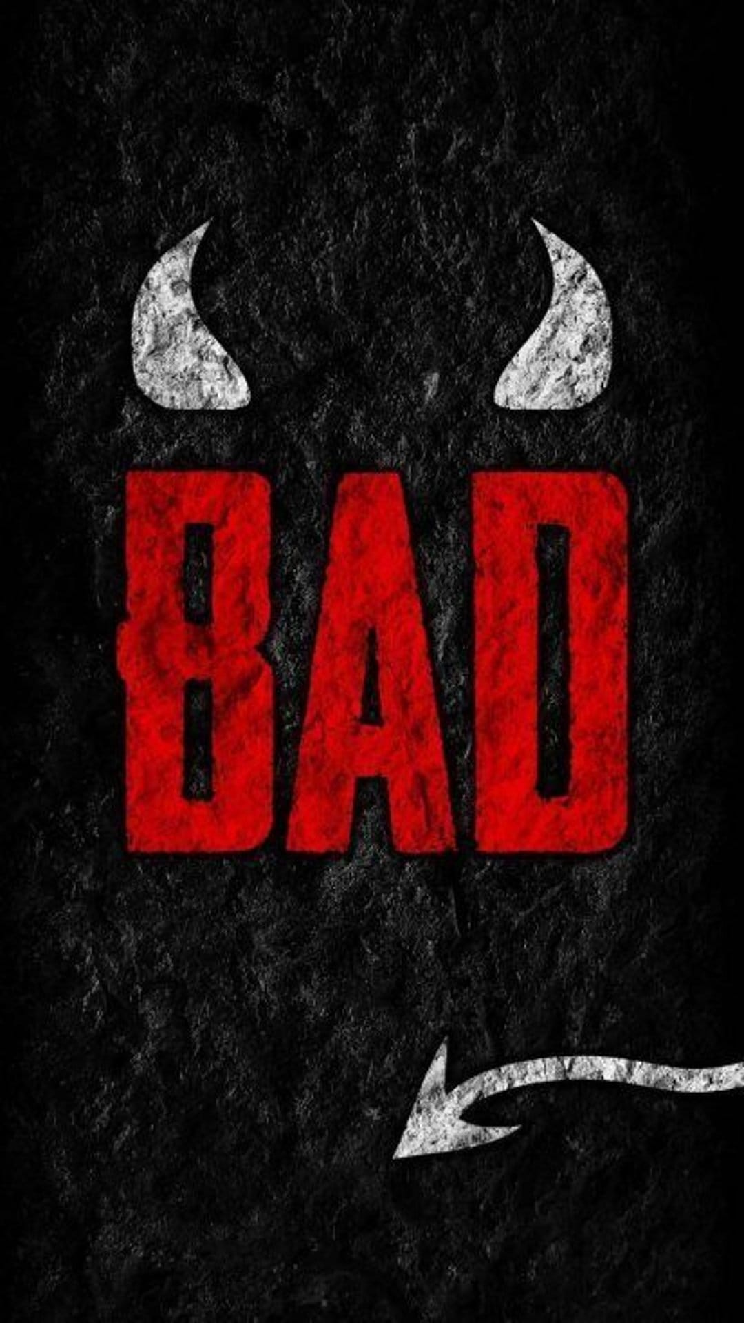 Red BAD lettering with white devil horns and tail rests on a dark, textured charcoal background surface.