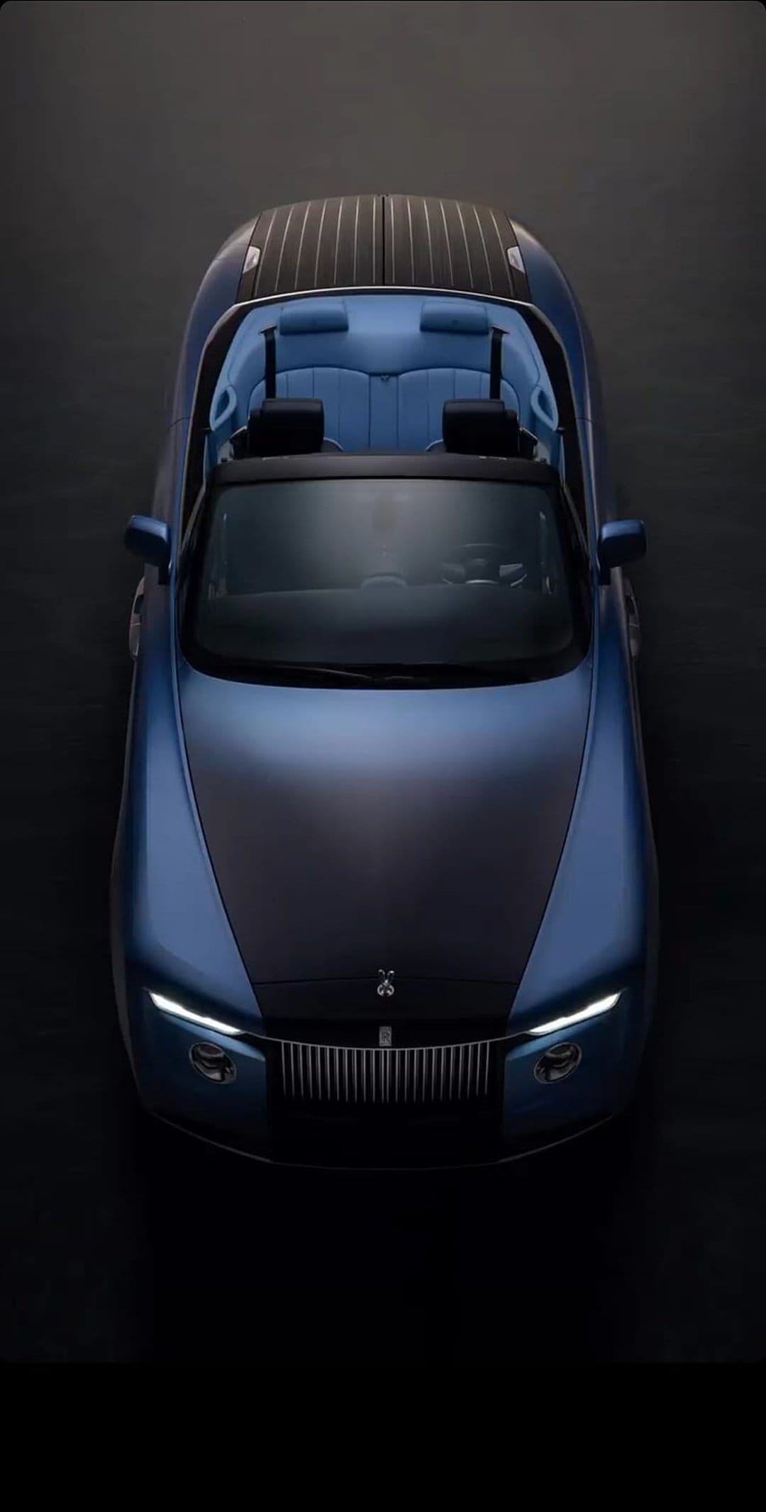 Rolls-Royce Boat Tail car features a blue finish and a wooden rear deck under soft, atmospheric lighting.